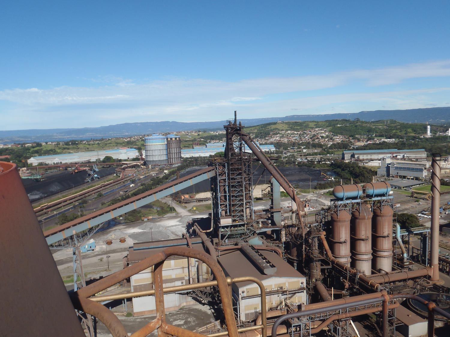 an aerial view of a factory with a blue sky in the background