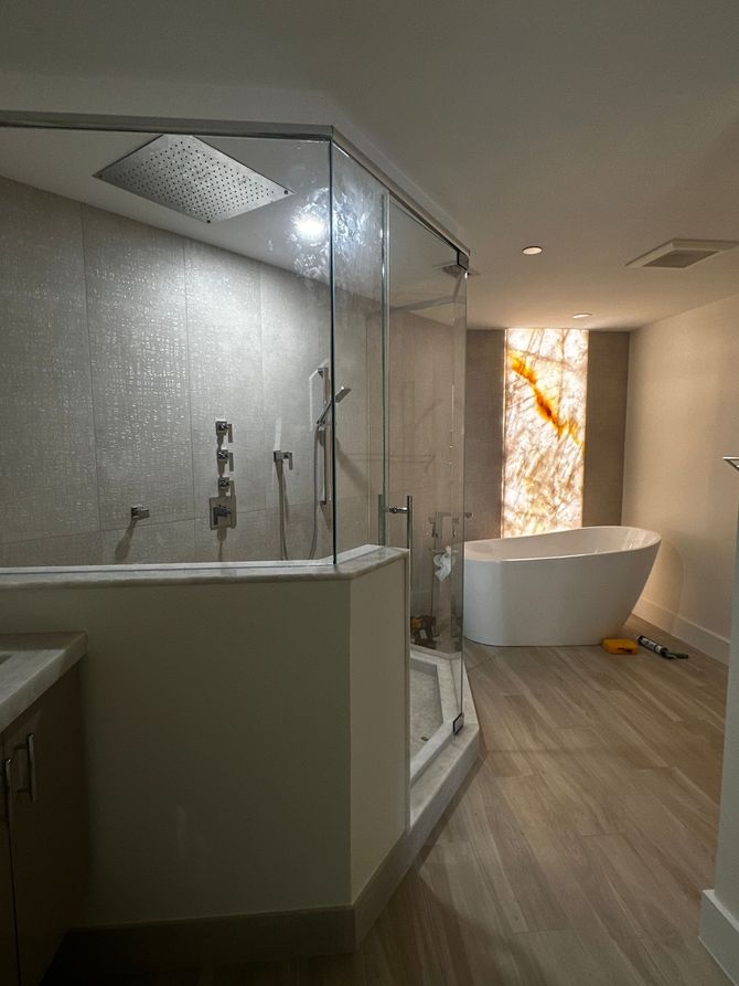 A bathroom with a bathtub and a shower stall