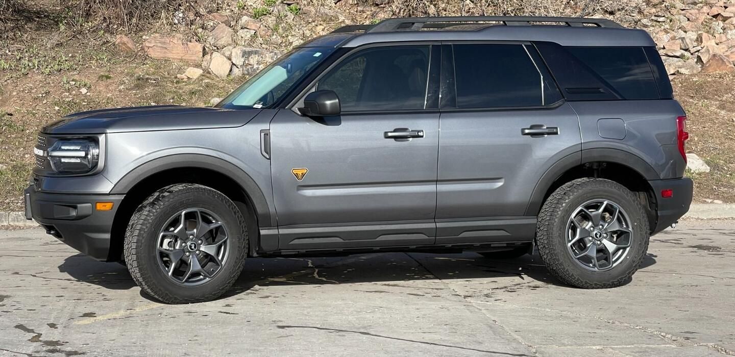 A ford bronco sport is parked on the side of the road.