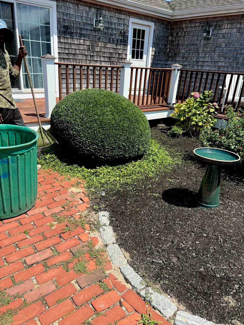 A Person Raking A Bush In A Yard — Hyannis, MA — DF Landscaping