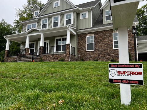 A large house with a for sale sign in front of it.