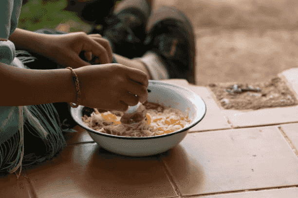 A person is eating cereal from a bowl with a spoon.