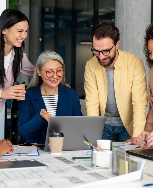 A group of people are looking at a laptop computer.