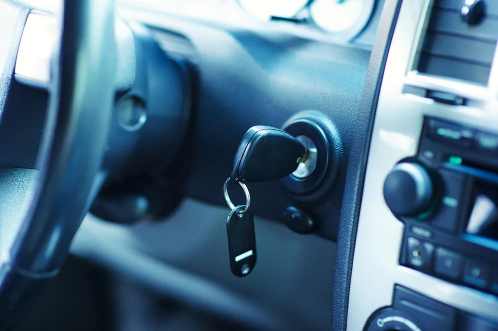 Car key inserted into the ignition start lock.