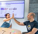 A man and a woman are giving each other a high five