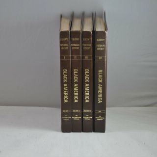 Four books titled black america are lined up on a table