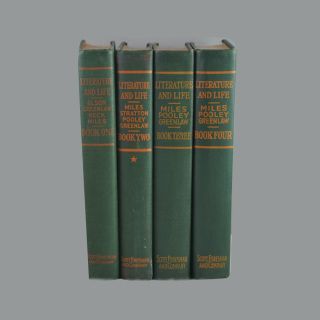 Four green books titled literature and life are stacked on top of each other