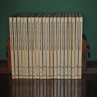 A row of books on a shelf one of which is titled the queen