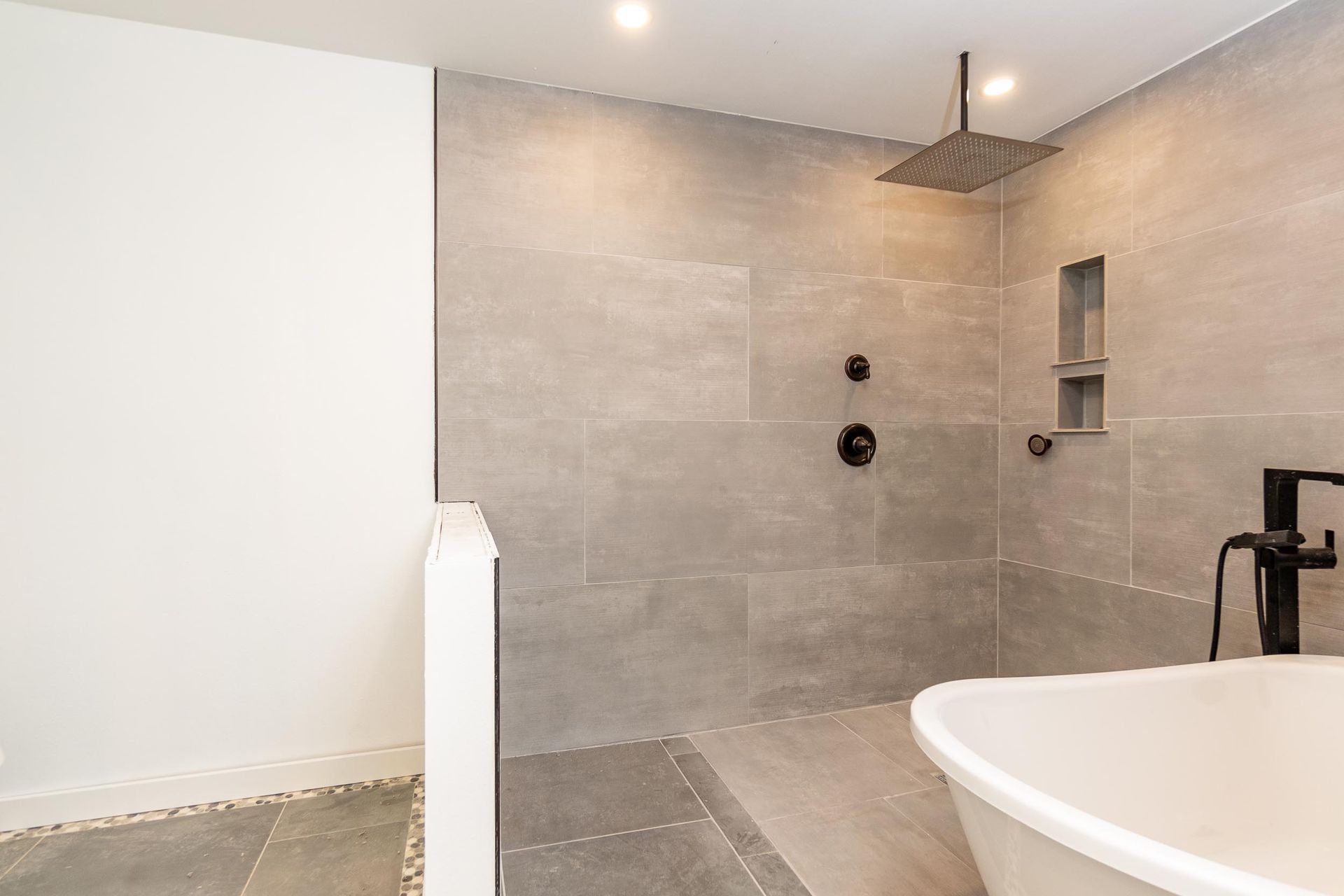A bathroom with a walk in shower and a bathtub.