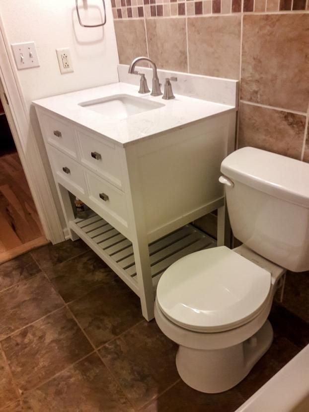 A bathroom with a sink , toilet and bathtub.