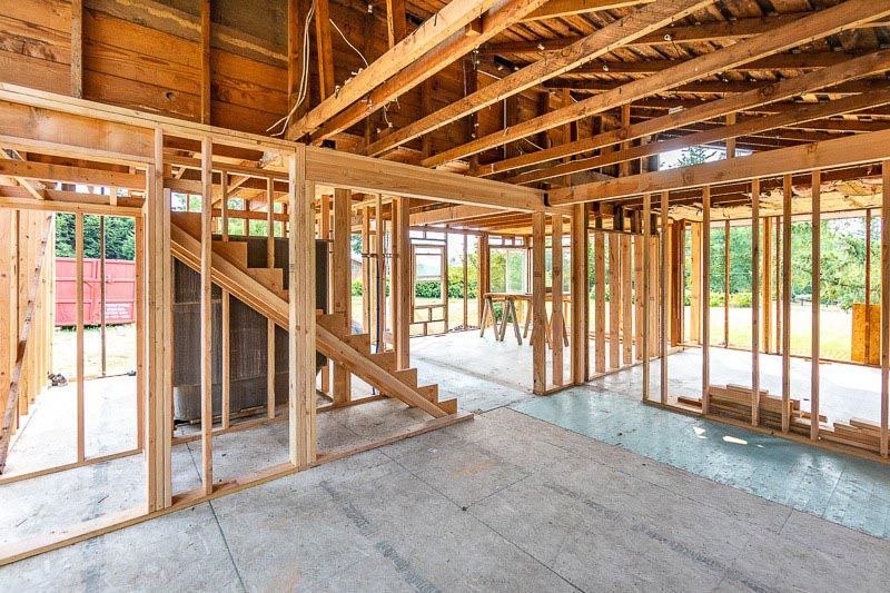 The inside of a house under construction with wooden beams.