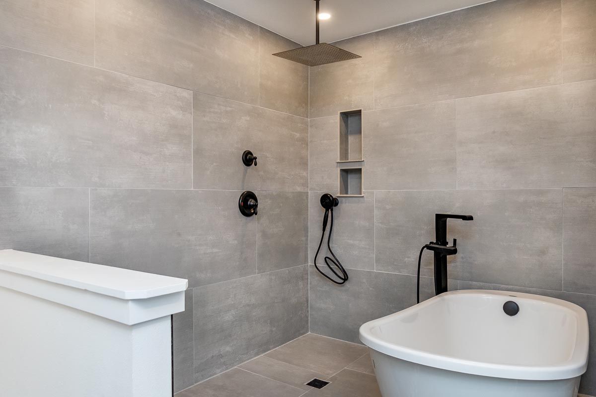 A bathroom with a bathtub and a shower.