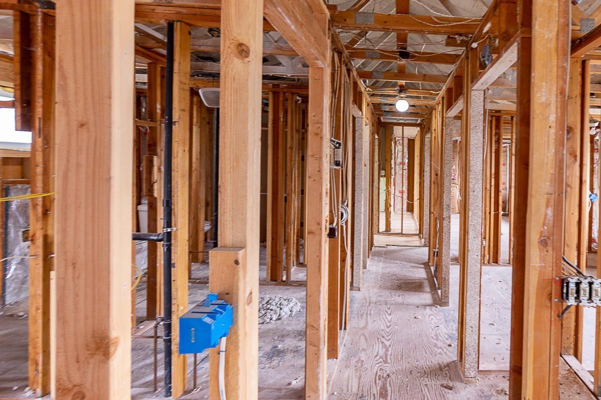 The inside of a house under construction with wooden beams.
