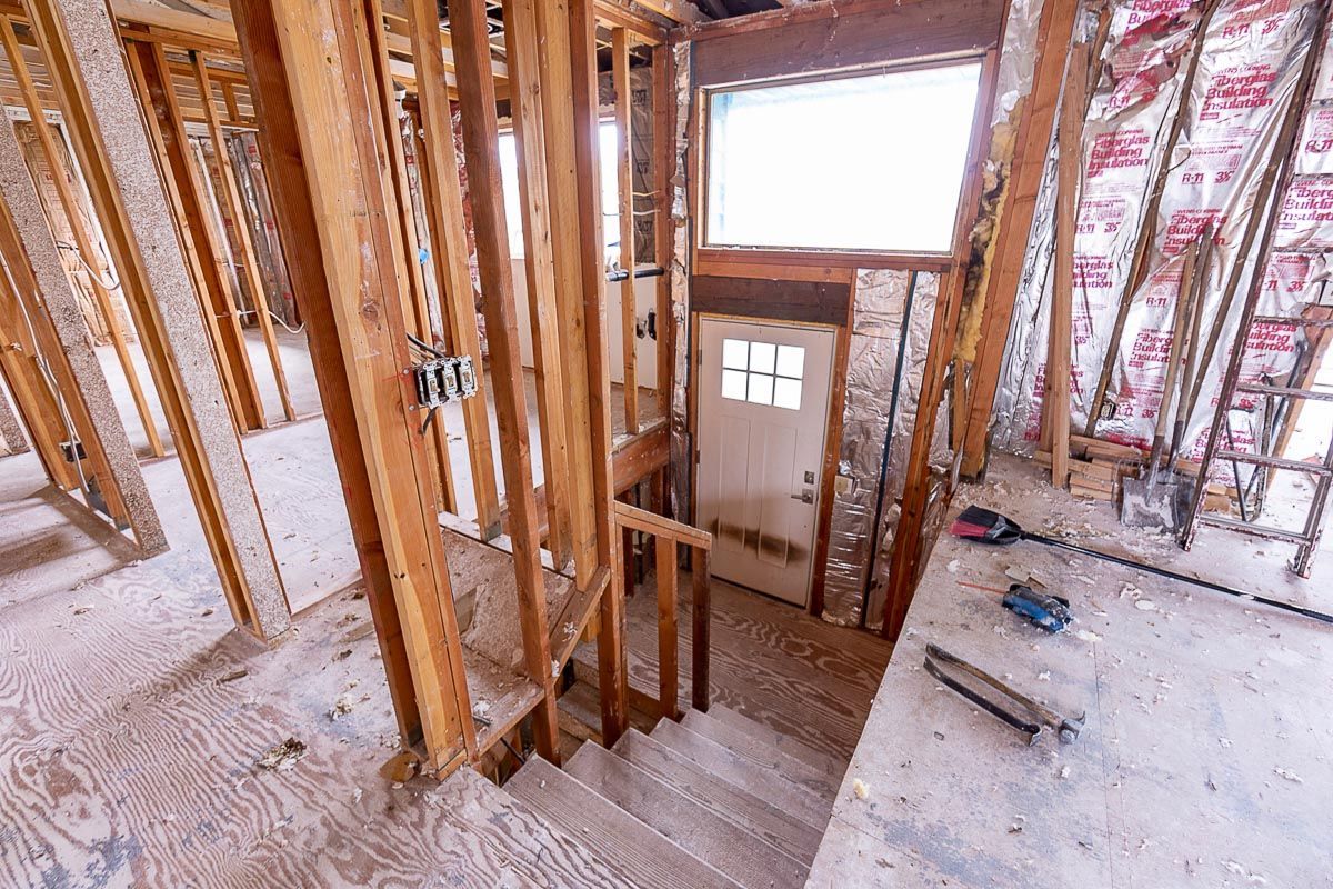 A house is being built with wooden beams and a door.