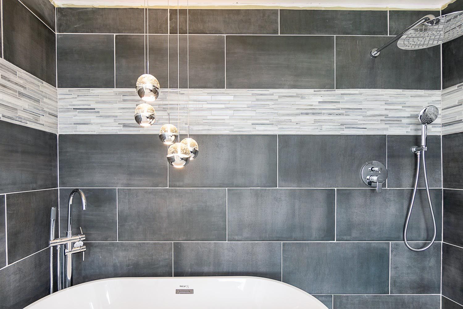 A bathroom with a bathtub and a shower.
