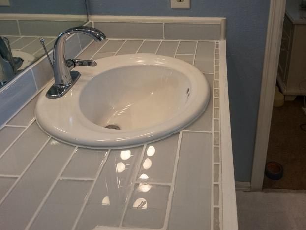 A bathroom sink with a faucet and a mirror