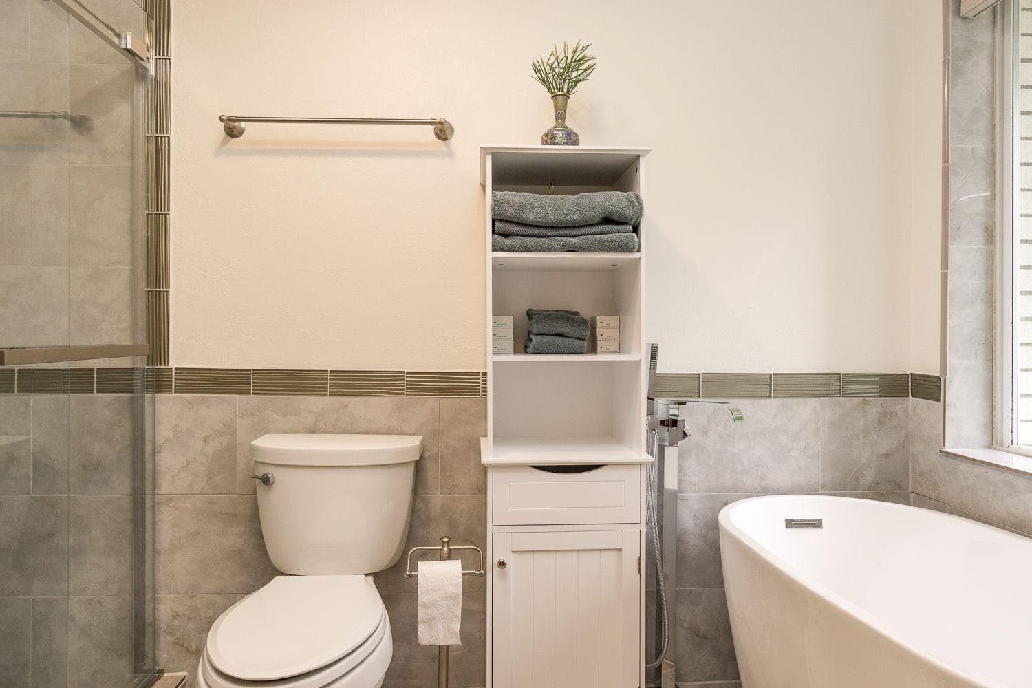 A bathroom with a toilet , sink , and bathtub.