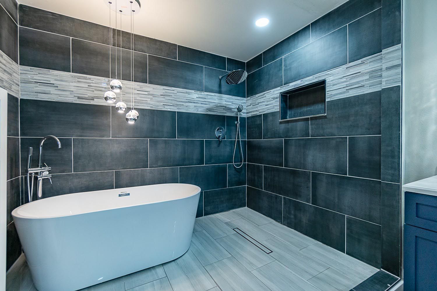 A bathroom with a bathtub and a shower.