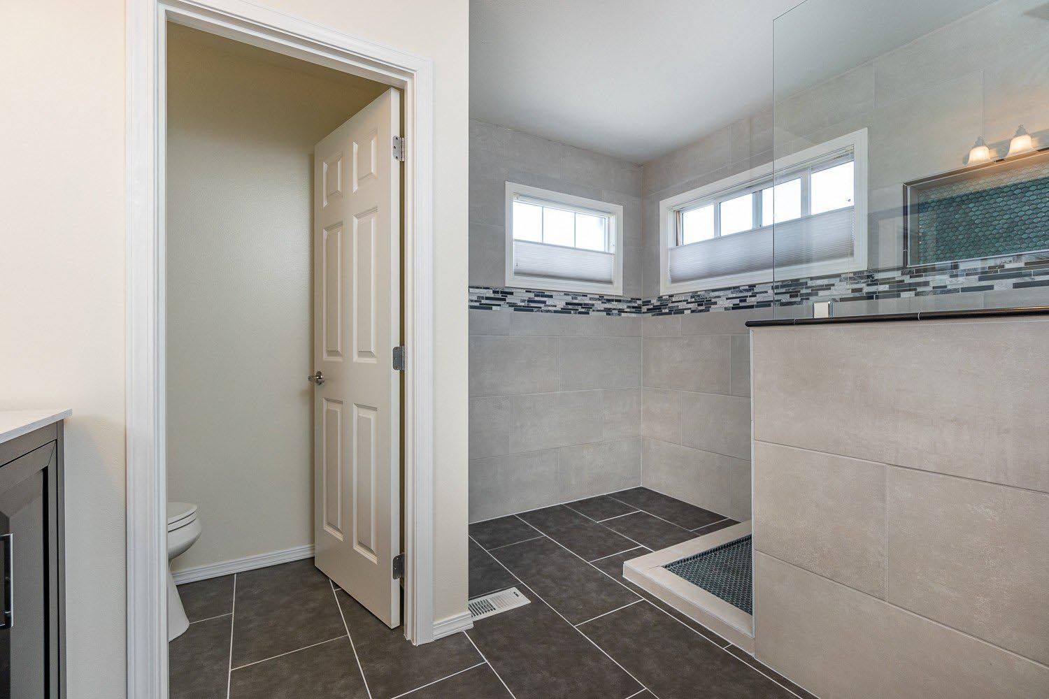 A bathroom with a walk in shower and a toilet.