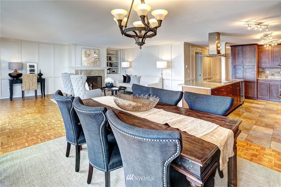 Dining room with a table set for six and a chandelier.