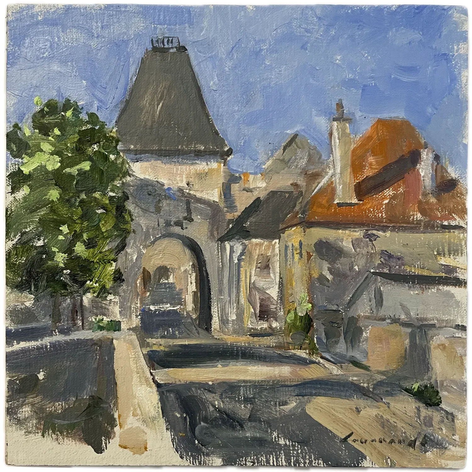Hands decorating a Christmas wreath with dried fruit and greenery on a wooden table.