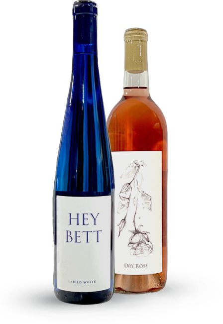 Two wine bottles: one blue, labeled 