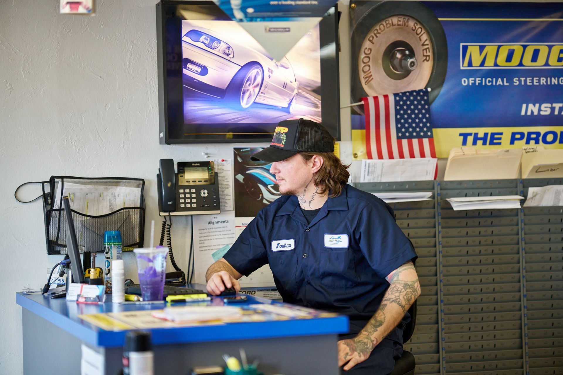 Staff sits at a desk in an auto shop | Linville Brothers