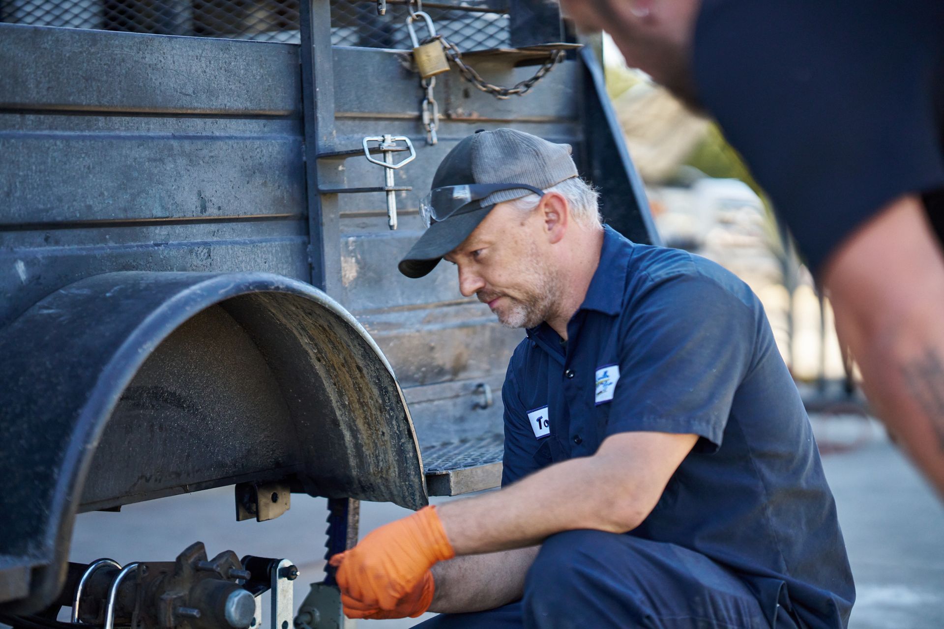 Mechanic inspecting a trailer's wheel | Linville Brothers