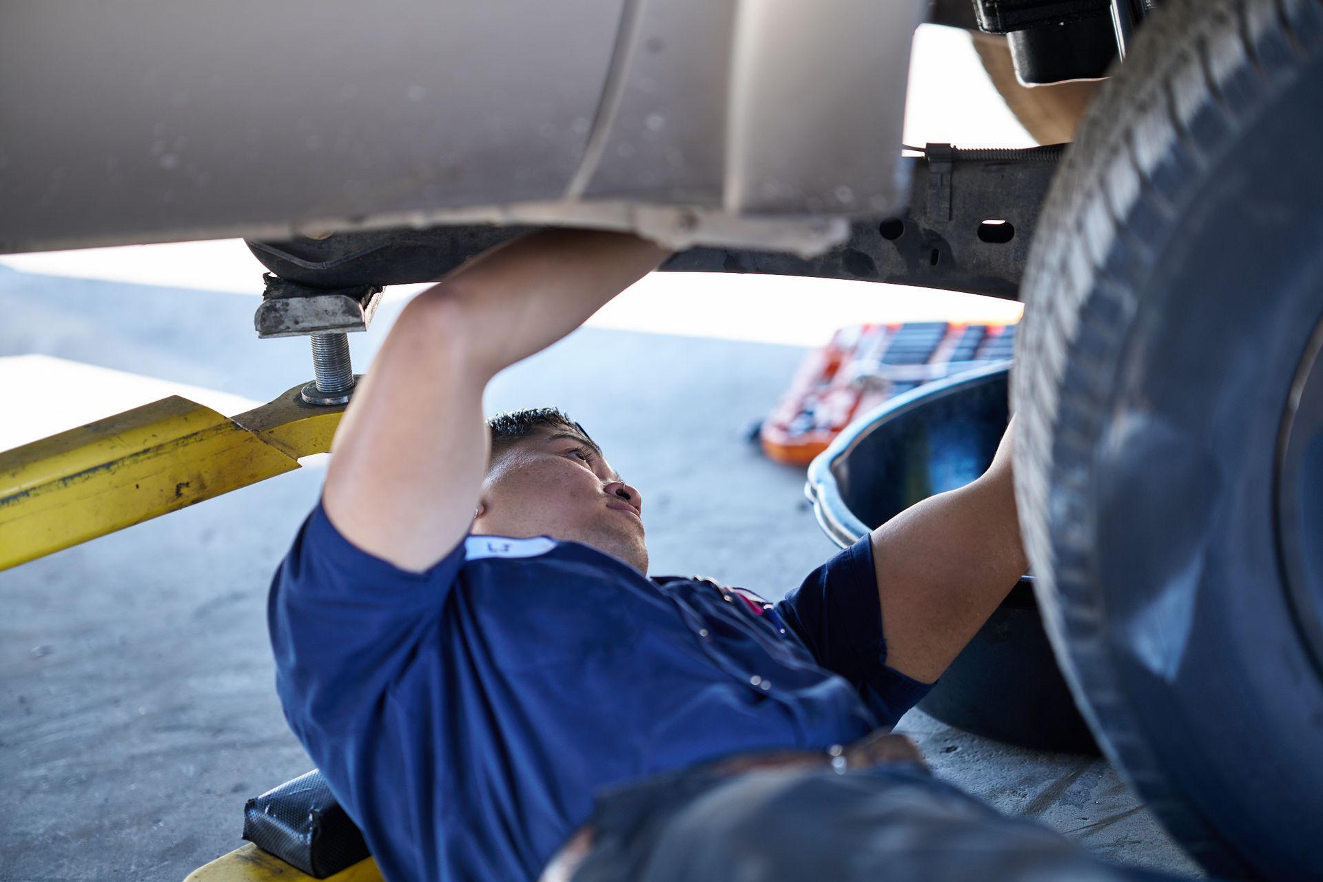 Mechanic working under a vehicle | Linville Brothers