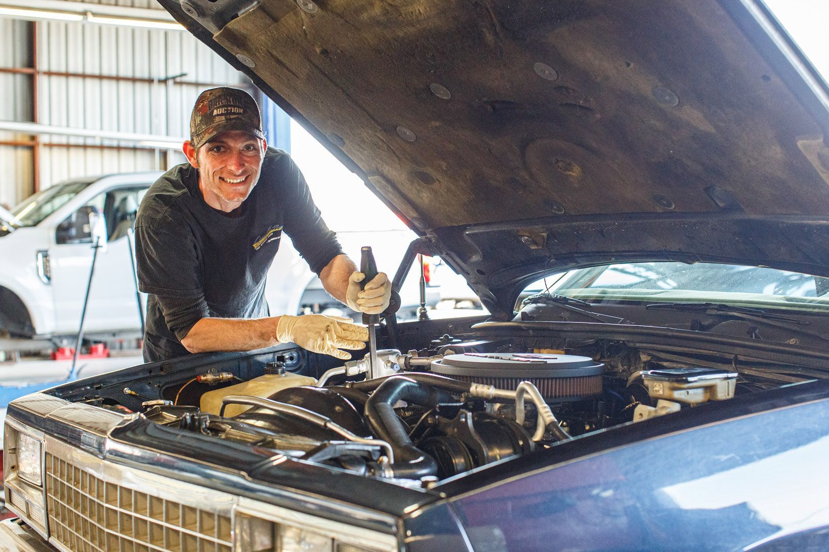 Mechanic Working Under Open Hood Of Classic Car | Linville Brothers