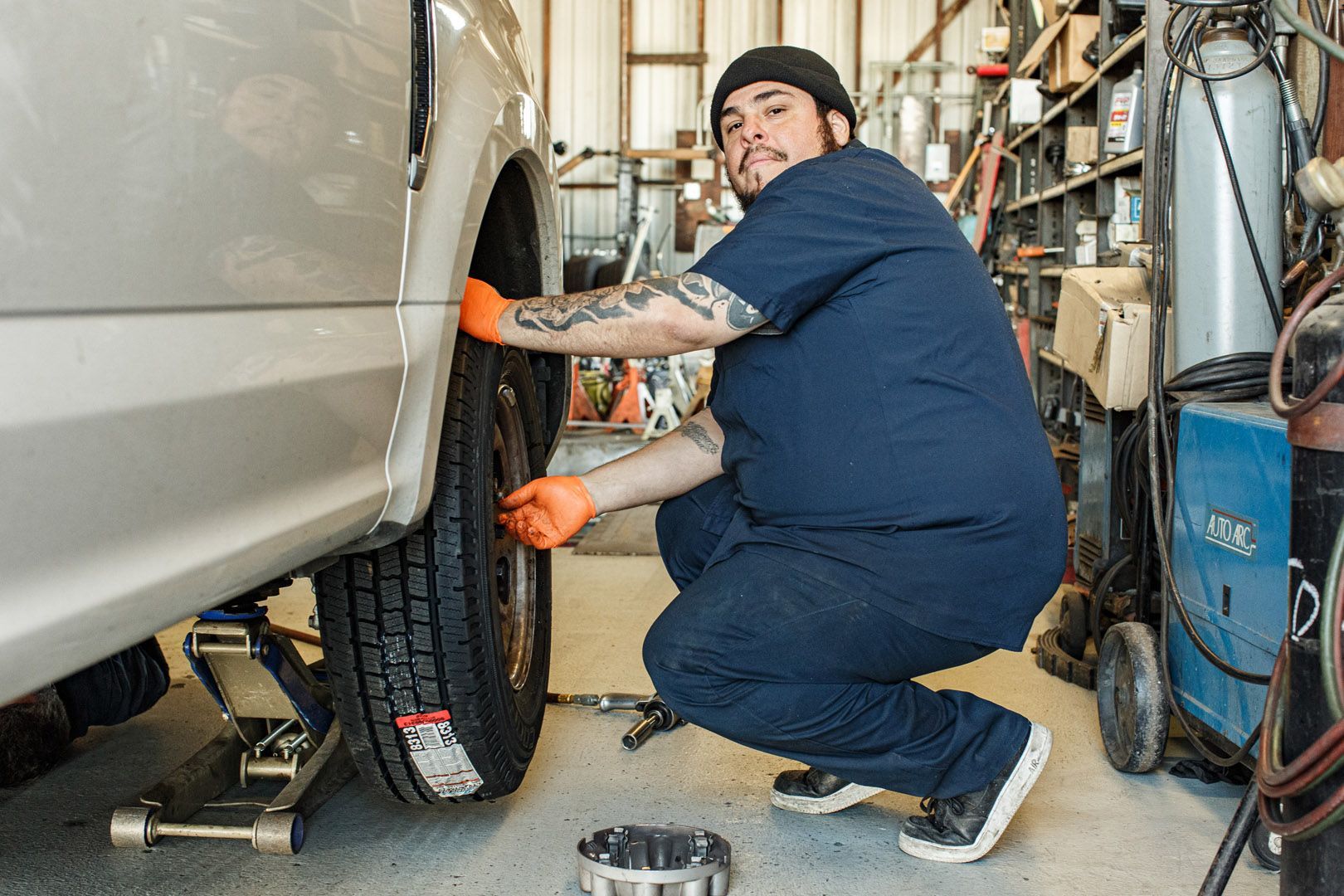 Mechanic Performing Tire And Wheel Installation On Vehicle | Linville Brothers