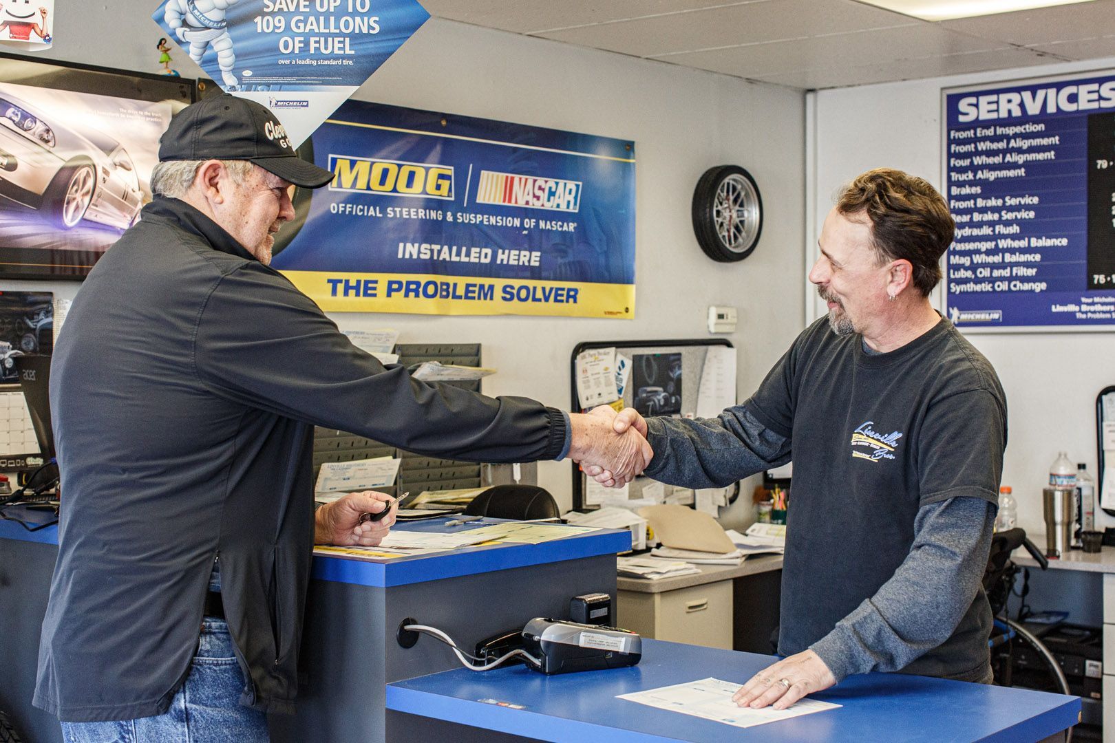 Mechanic Shaking Hands With Customer At Service Counter | Linville Brothers