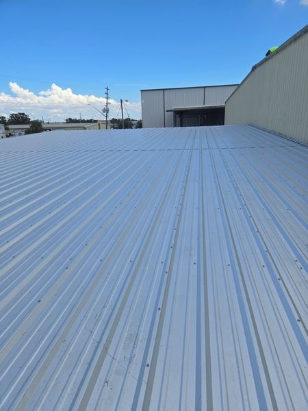Metal roof of a building with blue sky in the background.