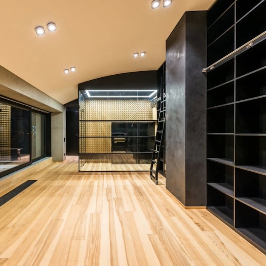 Open-concept living space with kitchen island, fireplace, and light wood floors.