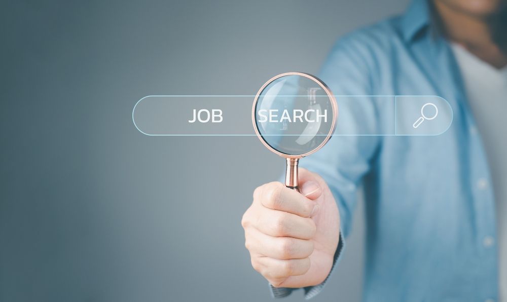 Person holding a magnifying glass over 