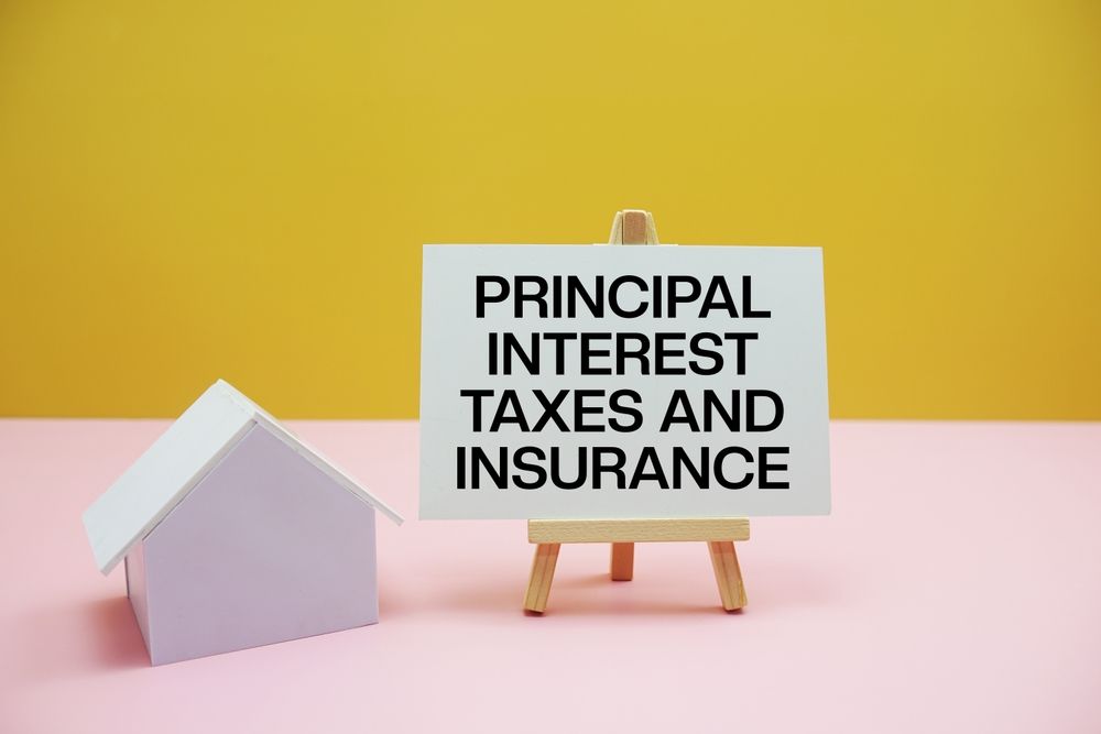 Small house beside a sign on an easel reading “PRINCIPAL INTEREST TAXES AND INSURANCE” against yellow and pink backgrounds.