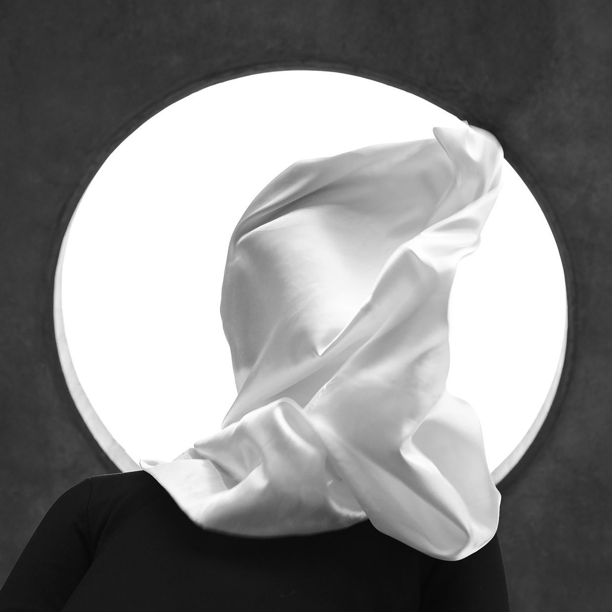 A person with a white cloth covering their face