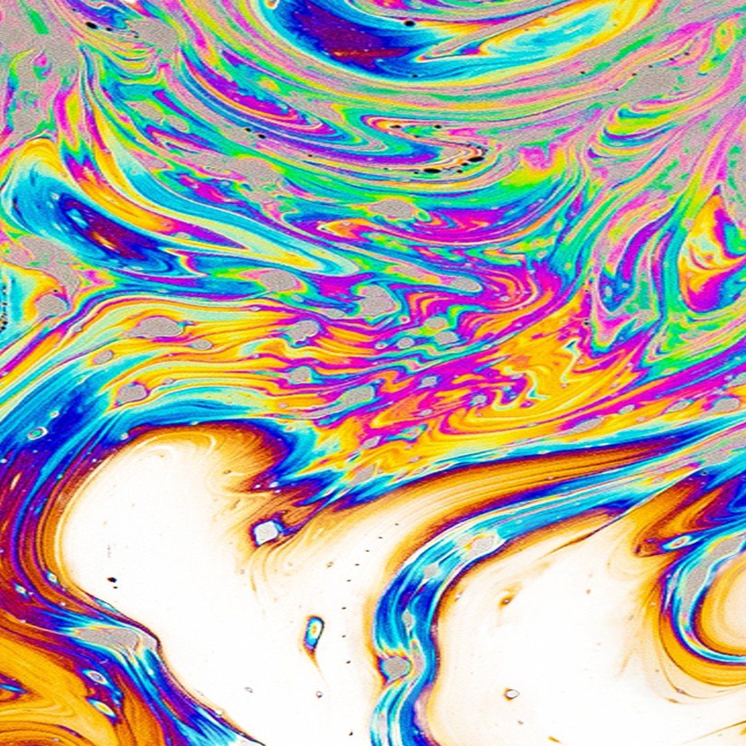 Abstract, iridescent colors swirl in patterns reminiscent of a soap bubble.