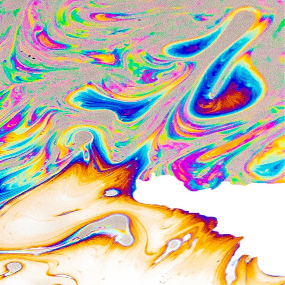 Colorful, swirling iridescent soap film with blue, yellow, and orange hues.