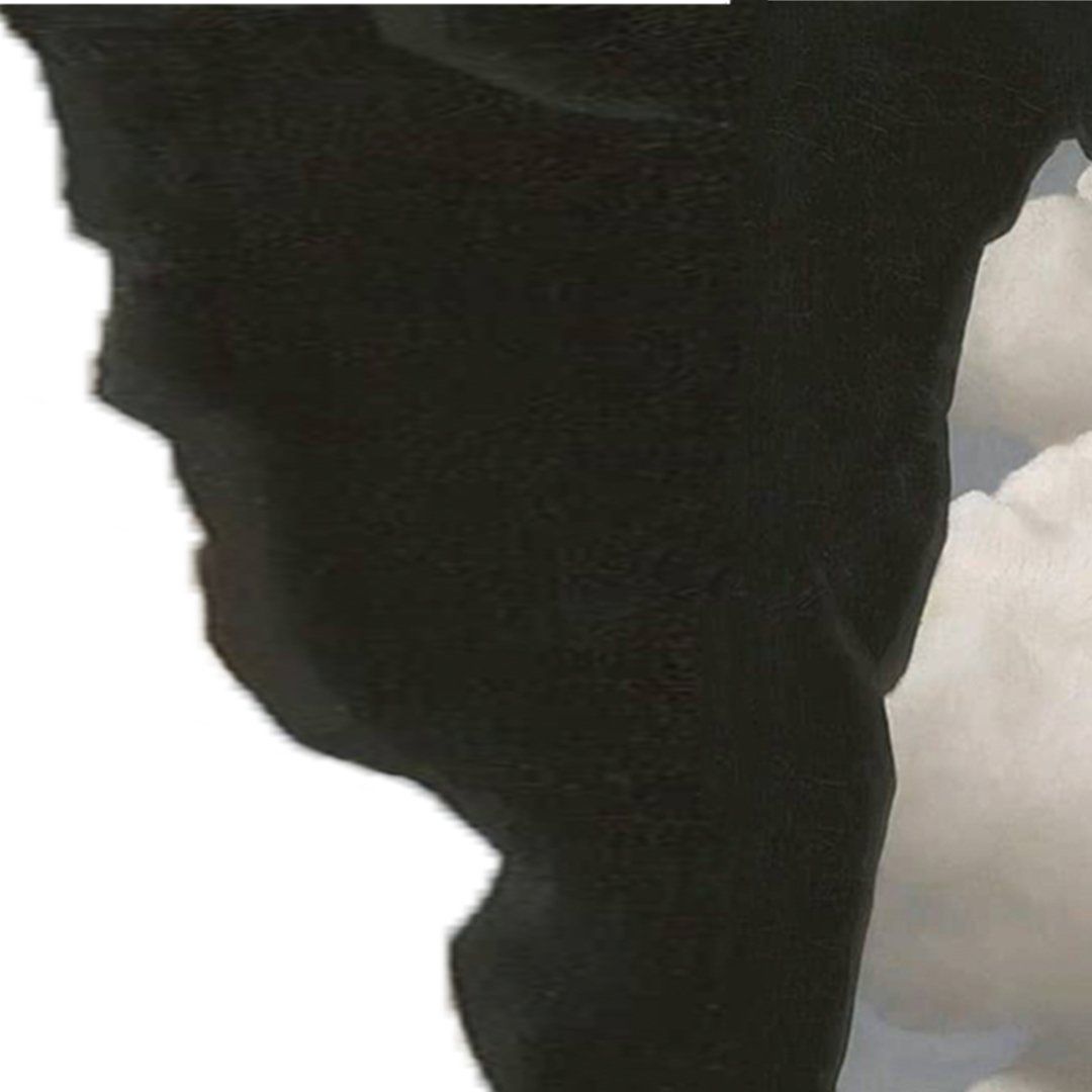 Black tower-like structure against cloudy sky.