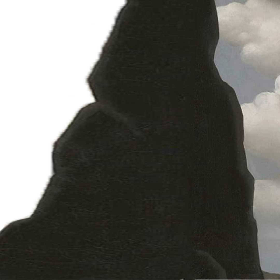 Silhouette of large, dark rock formation against a cloudy sky.