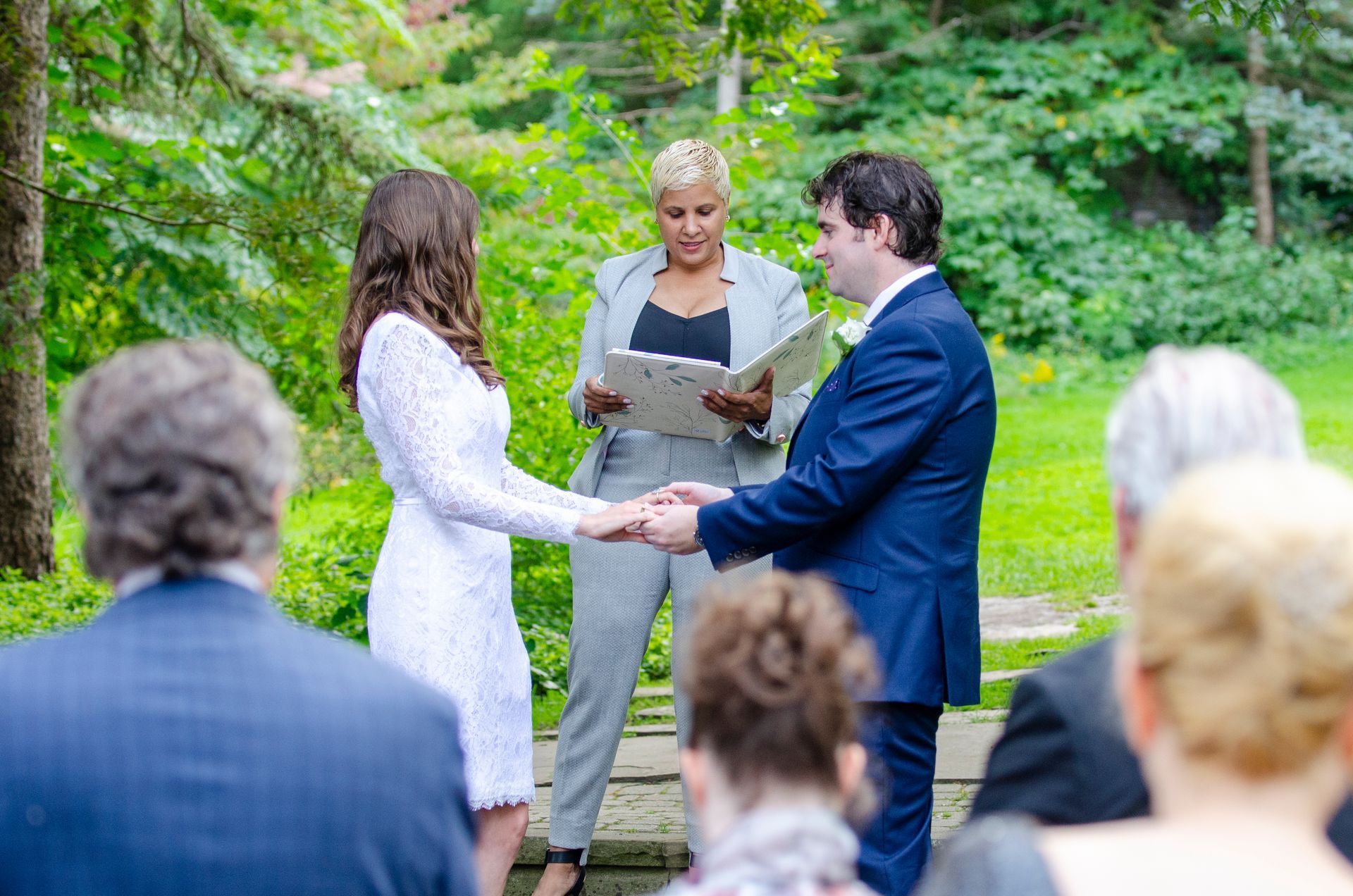 Couple exchanging vows at outdoor wedding ceremony.