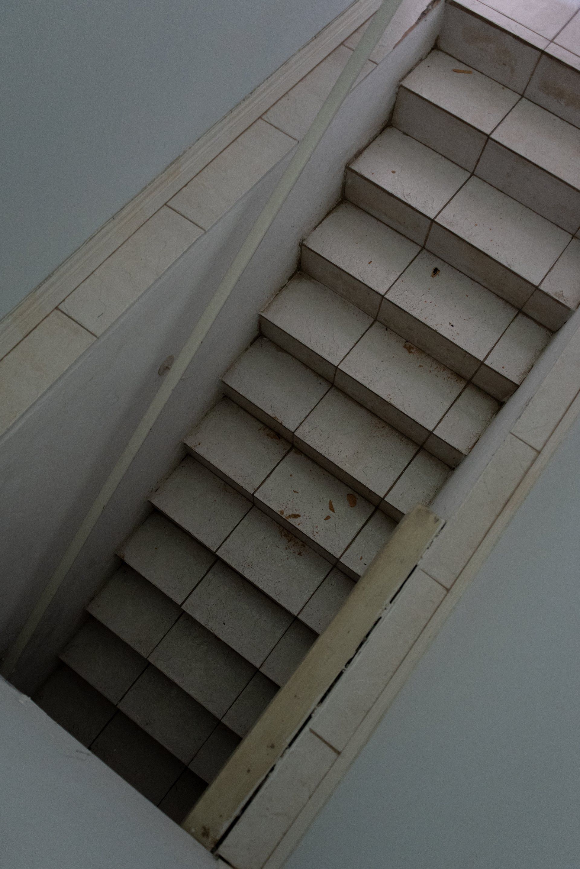 A set of stairs going down a hole in the floor.