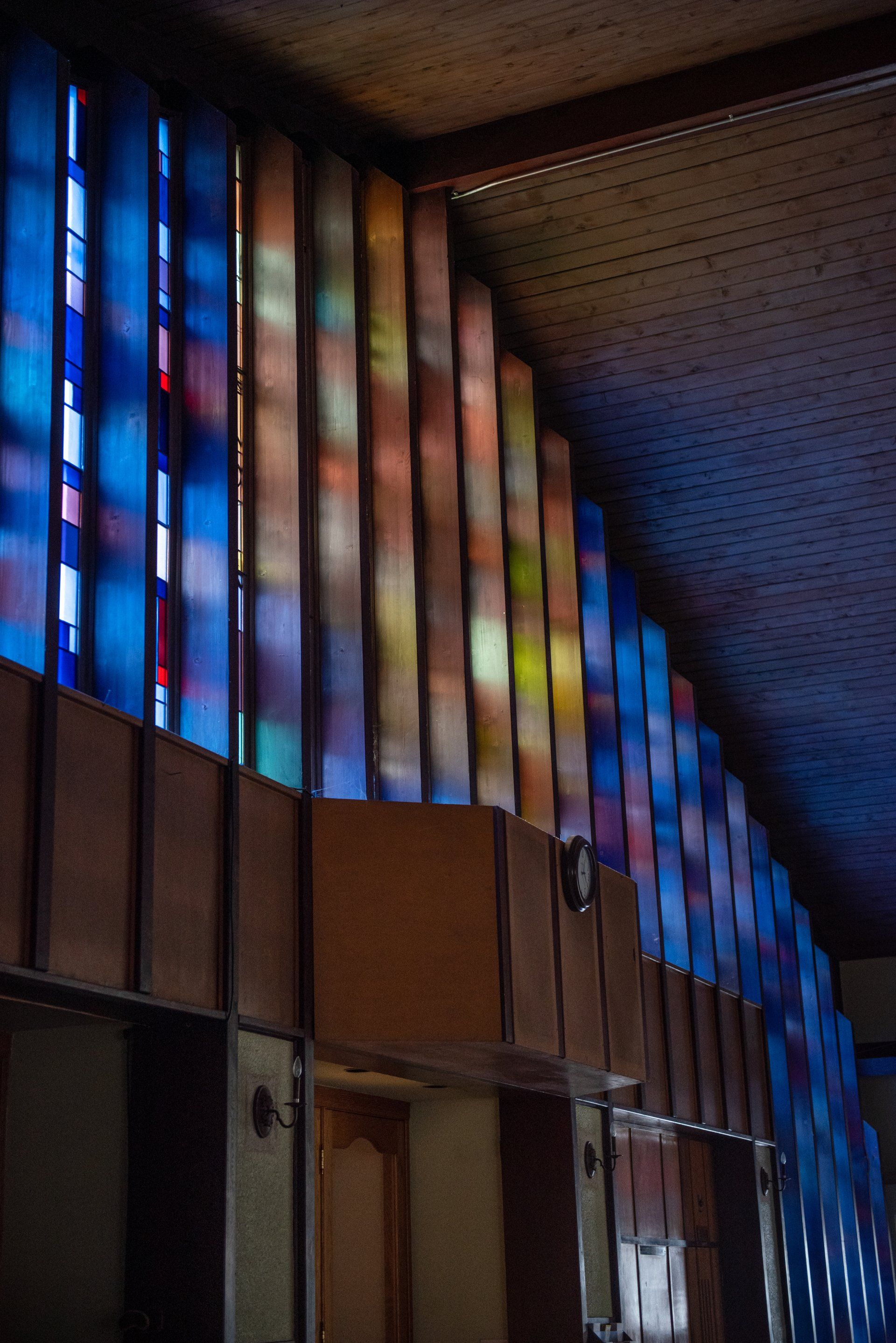 A row of stained glass windows in a church.