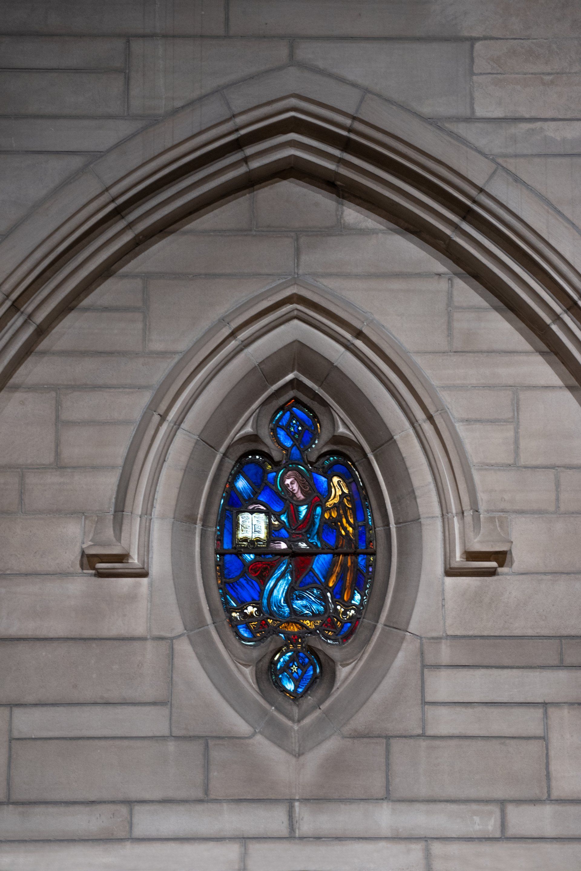 A stained glass window on the side of a building.