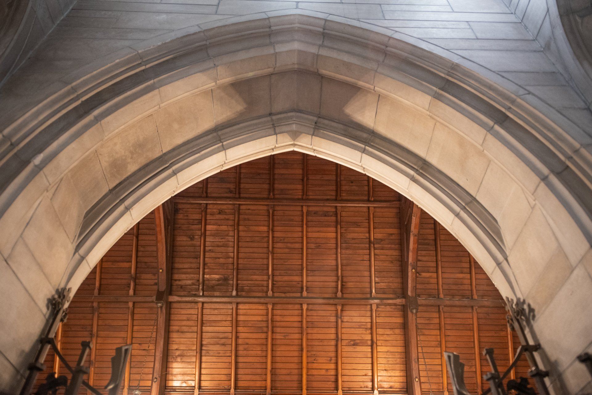 A church with a wooden ceiling and a stone archway.