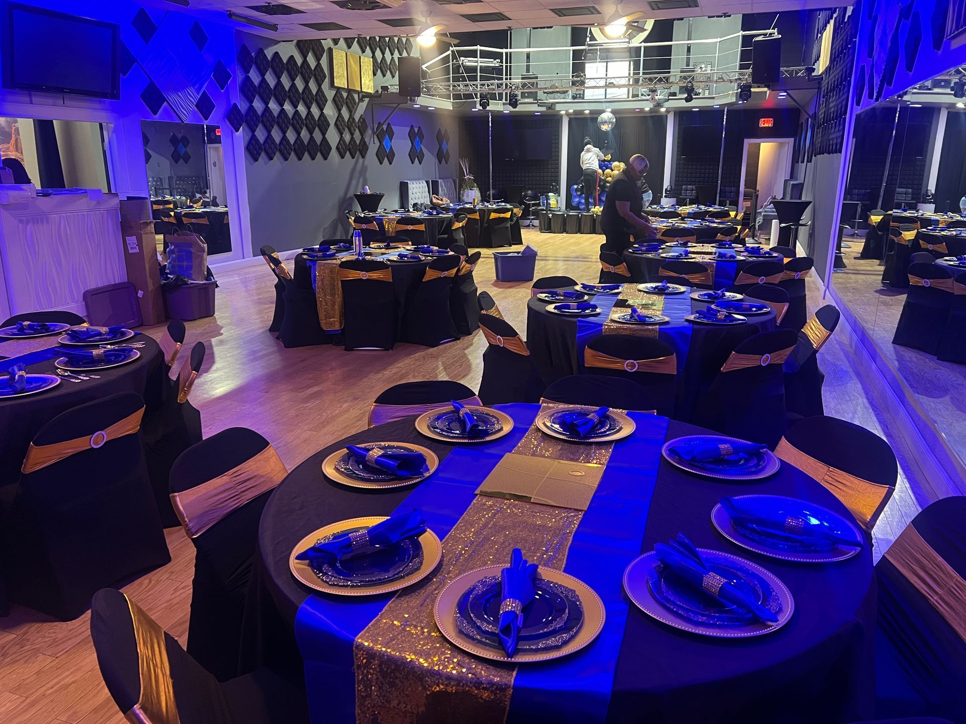 A room filled with tables and chairs set up for a party.