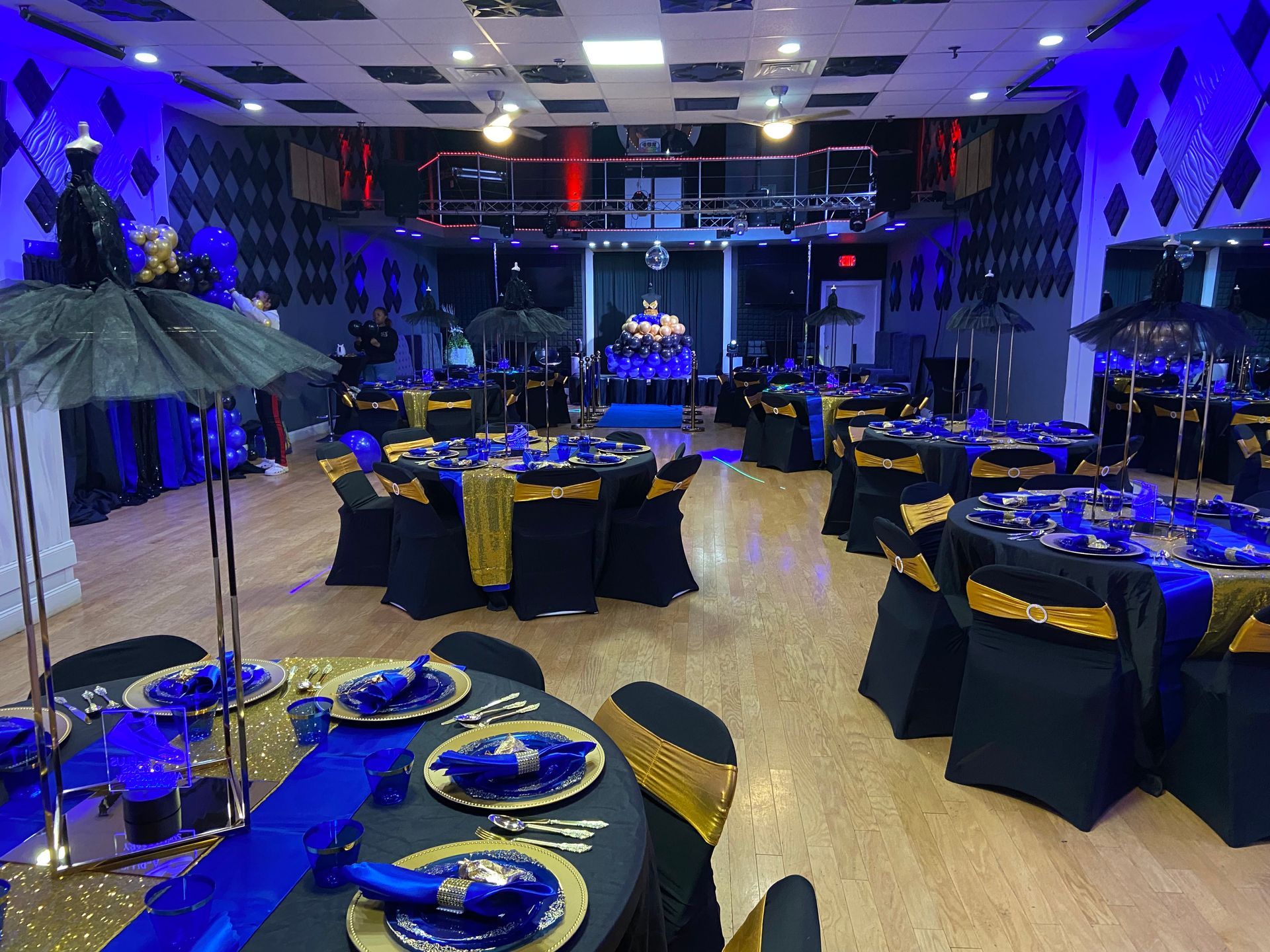 A large room with tables and chairs set up for a party.