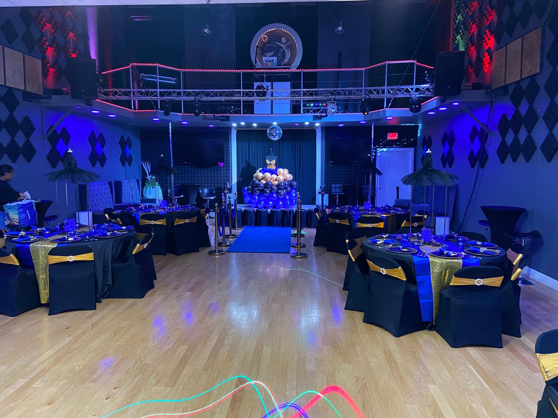 Three children are sitting at a table wearing halloween masks.