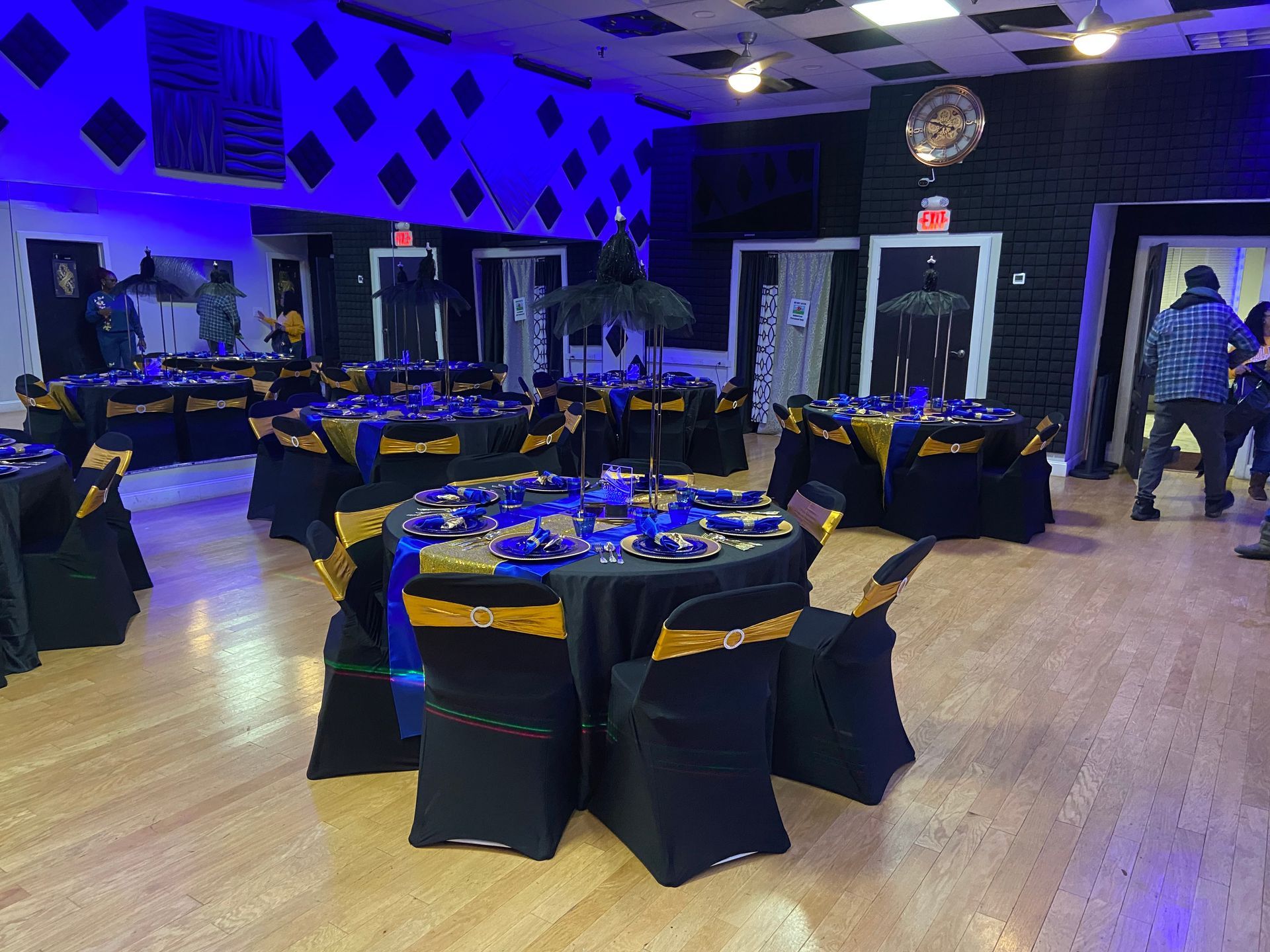 A large room with tables and chairs set up for a party.